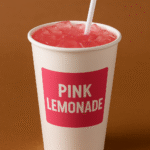 Image of pink lemonade in a togo cup.