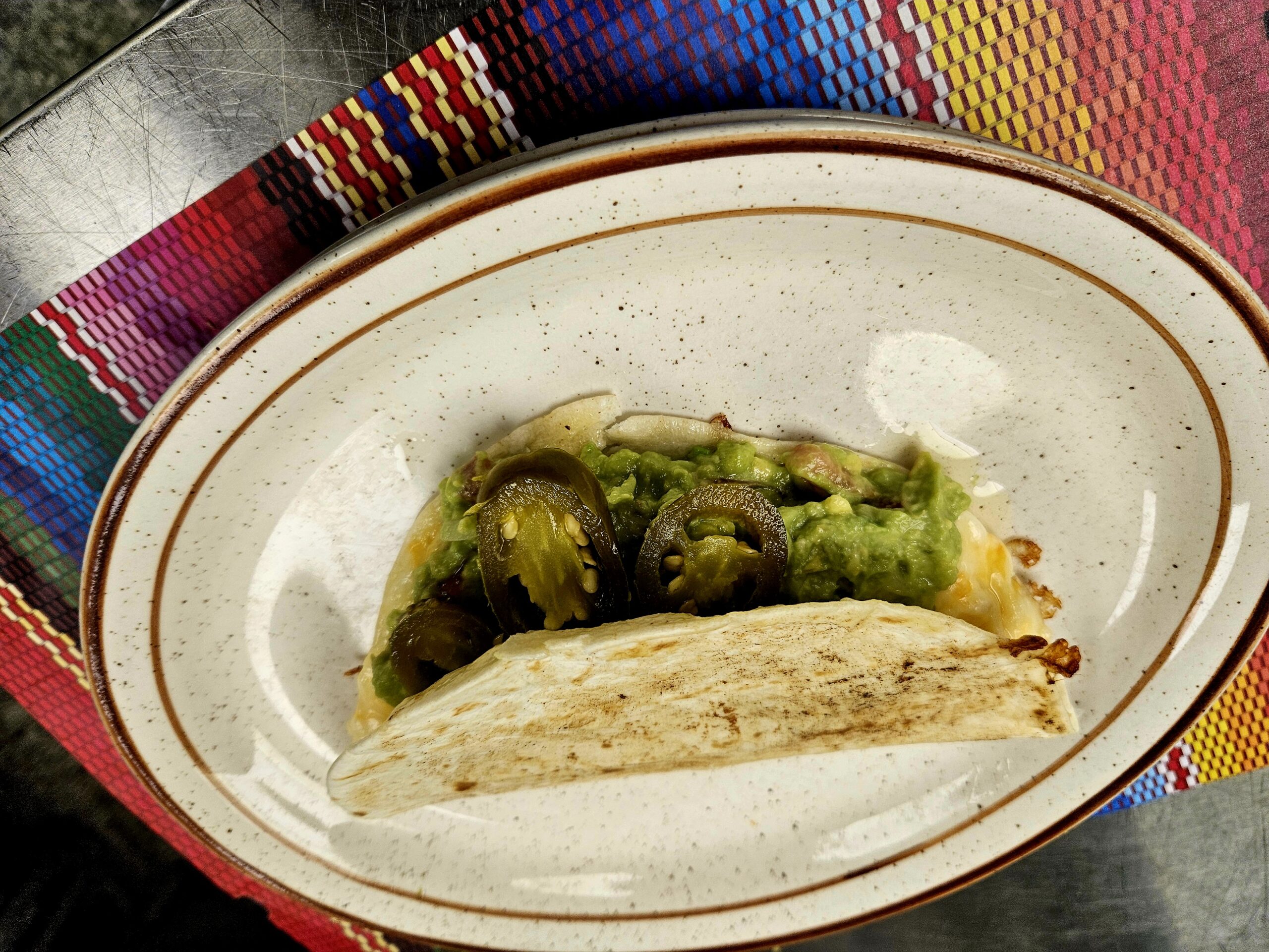 This is an image of a Nacho Taco at Manuels Taco Hut